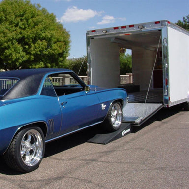 Blue muscle car driving up Race Ramps RR-TR-4 trailer ramps into an enclosed trailer