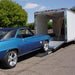Blue muscle car driving up Race Ramps RR-TR-4 trailer ramps into an enclosed trailer