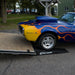 Flamed Firebird driving up a Race Ramps RR-TR-8XL trailer ramp