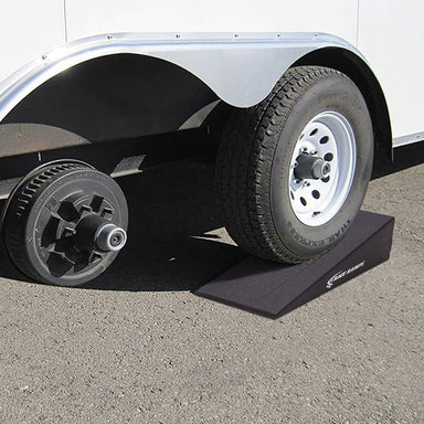 Trailer Side Kick lifting one tire of a tandem axle trailer for a tire change