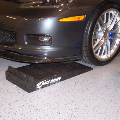Race Ramps Trak-Jax positioned in front of a low Corvette front wheel