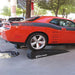 Dodge Challenger raised on Race Ramps XT ramps at a show