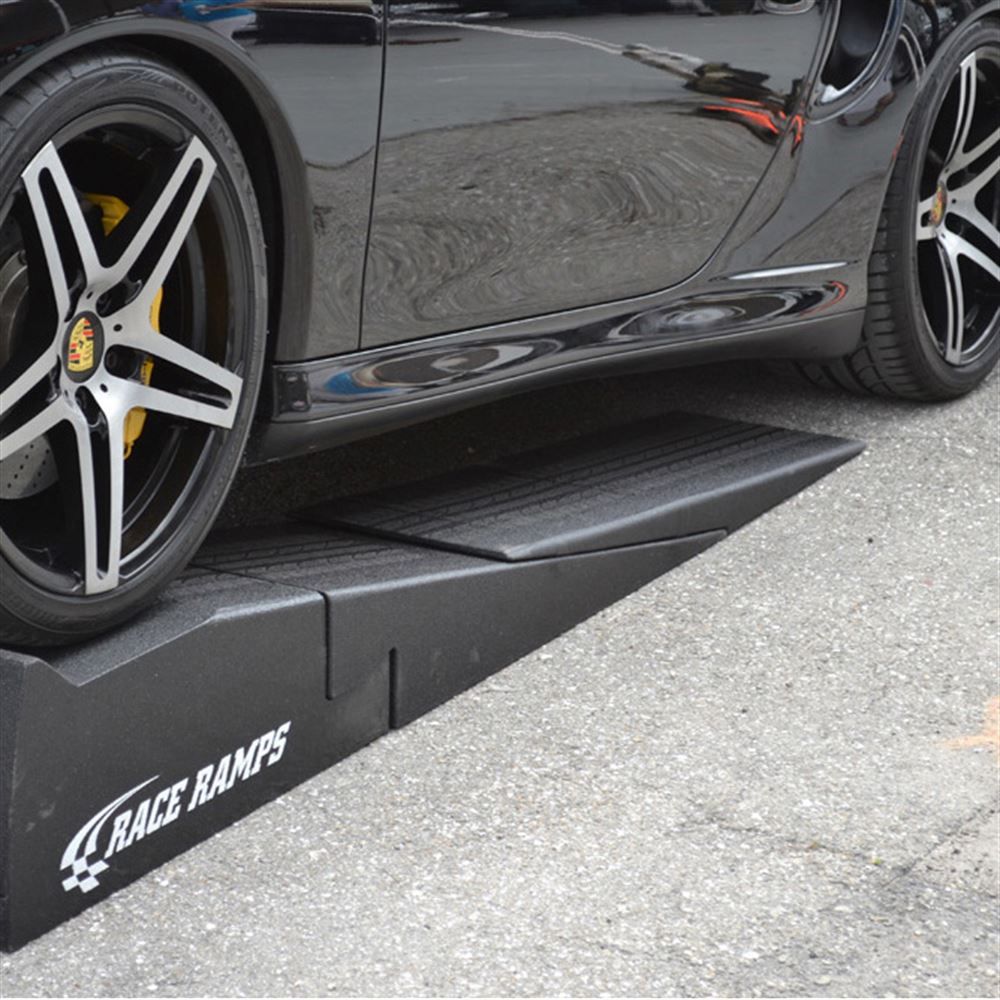 Low sports car climbing a Race Ramps XTender into a car ramp